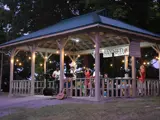 A band playing music under a pavillion.
