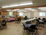 A community hall with small tables and chairs