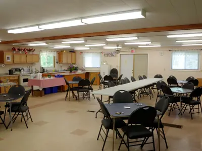 A community hall with small tables and chairs