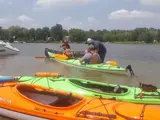 Kayaks and canoes on the water