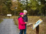 people reading an interpretive sign
