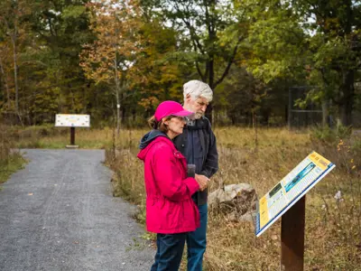 people reading an interpretive sign