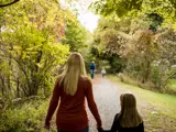 Woman and daughter walking on trail