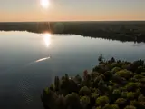 Drone shot of a boat on water in the sunset