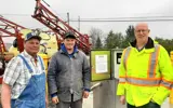 Local farmers and municipal employee in front of new bulk water station