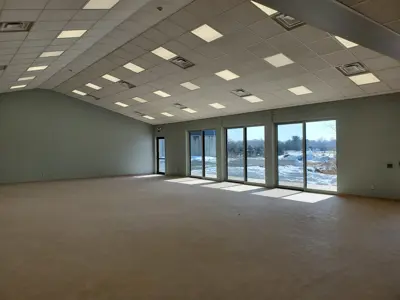 A large hall with vaulted ceilings and large windows on the one wall