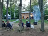 People sitting in lawn chairs facing a band playing music outside.
